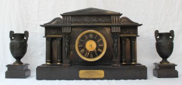 An impressive Edwardian black slate mantle clock of architectural design with a portico,