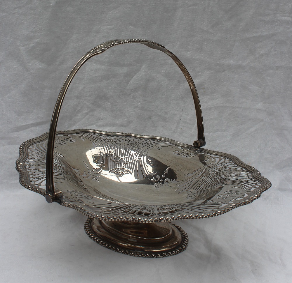 A George V silver swing handled cake basket,