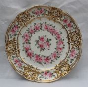 A Nantgarw porcelain plate, the moulded border highlighted with gilt decoration,