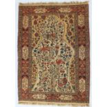 A woolwork tapestry rug decorated with a tree of life, birds and fruit,