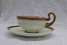 A Swansea Paris flute cup and saucer, with a ribbed body and gilt rims,