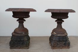 A pair of impressive cast iron urn planters with a flared gadrooned rim,