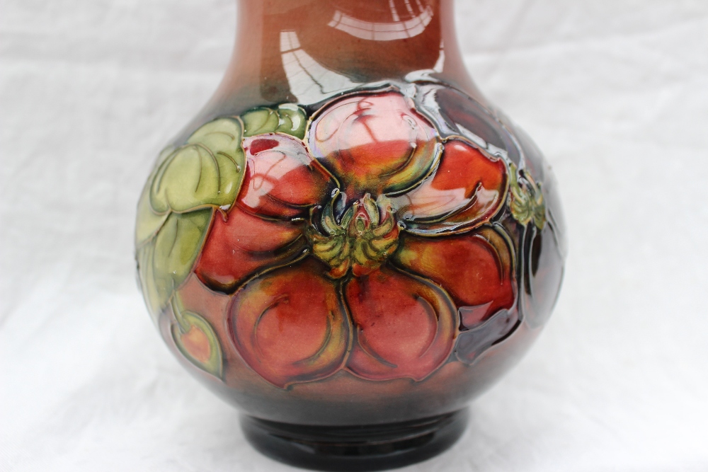A Moorcroft vase decorated in the clematis pattern, to a graded red ground, - Image 2 of 6