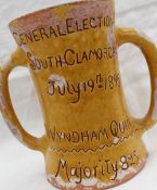 An E Jenkins Ewenny pottery twin handled mug in mustard yellow inscribed "General Election,