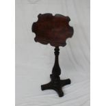 A Victorian walnut reading screen the shaped screen with a book rest on a telescopic column,