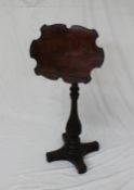 A Victorian walnut reading screen the shaped screen with a book rest on a telescopic column,