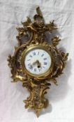 An ormolu wall clock, of rococo form decorated with scrolls and leaves,