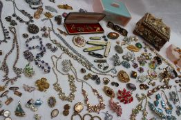 Assorted costume jewellery including necklaces, hat pins, cufflinks, earrings, penknives, brooches,