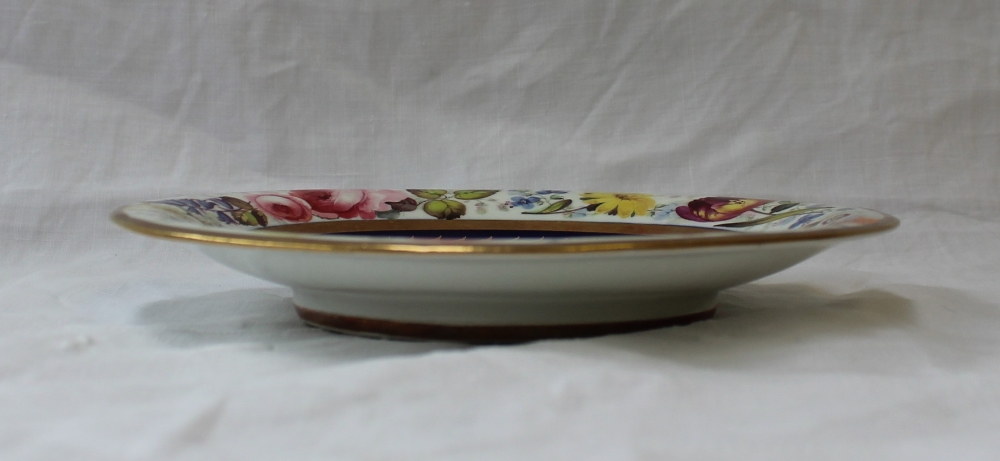 A Swansea porcelain saucer dish, painted to the border with a continuous band of garden flowers, - Image 2 of 4