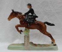 A Beswick model of a Huntswoman jumping a fence,