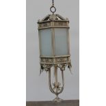 A cream coloured hanging lantern and arm, with six glazed panels, and leaf mounts,