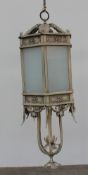 A cream coloured hanging lantern and arm, with six glazed panels, and leaf mounts,