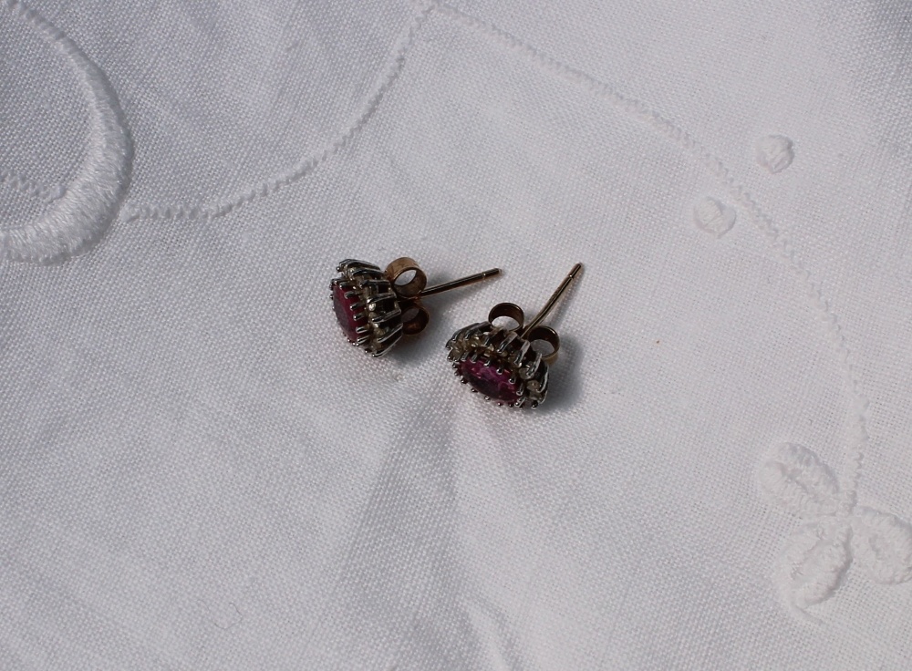 A pair of ruby and diamond cluster ear studs, each set with an oval mixed cut ruby, - Image 3 of 3