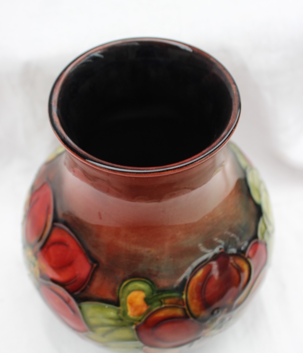 A Moorcroft vase decorated in the clematis pattern, to a graded red ground, - Image 5 of 6
