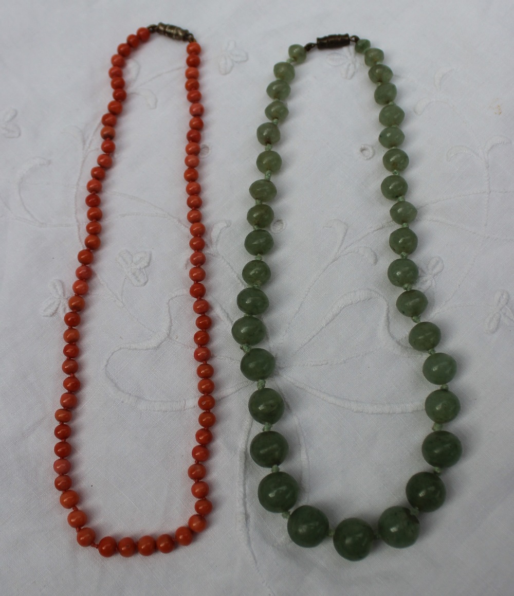 A green jade bead necklace, on a knotted cotton thread with a twist clasp, - Image 2 of 2