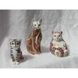 Three Royal Crown Derby porcelain paperweights in the form of cats in various poses