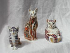 Three Royal Crown Derby porcelain paperweights in the form of cats in various poses