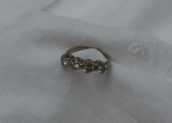 A four stone diamond ring set with four round brilliant cut diamonds in a line,