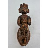 A model of a ships figure head depicting a winged maiden in a crown,