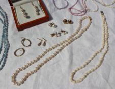 A pearl necklace together with pearl drop earrings, other earrings,