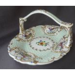 A 19th century English porcelain cake basket with vignettes of birds of paradise to a raised