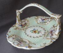 A 19th century English porcelain cake basket with vignettes of birds of paradise to a raised