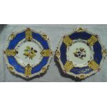 A pair of 19th century Rockingham porcelain plates with a shell and scroll moulded rim,