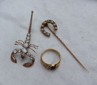 A horse shoe shaped pearl set stick pin in a yellow metal setting marked 18ct together with an 18ct