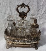 A William IV silver cruet stand, of oval form decorated with leaves, on four leaf capped legs,