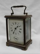 A 19th century French brass carriage clock, the enamel dial with Roman numerals and an alarm dial,