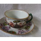 A Capodimonte porcelain tea cup and saucer, with moulded decoration decorated with figures,