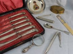 A set of six George V silver pistol handled knives together with a silver and pottery pin tray,