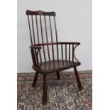 A 19th century stick back Windsor chair with a shaped cresting rail,