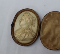 A carved ivory panel of oval form depicting Queen Anne,