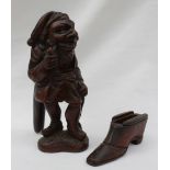 A Black forest novelty nut cracker, carved in the form of a standing figure holding a pipe,