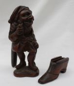 A Black forest novelty nut cracker, carved in the form of a standing figure holding a pipe,