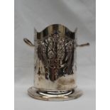 A George V silver twin handled bottle sleeve, with a piereced body on a spreading foot,