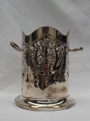 A George V silver twin handled bottle sleeve, with a piereced body on a spreading foot,