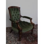 A Victorian walnut framed library chair with a carved back rail, button upholstered pad back,