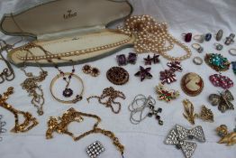 A collection of costume jewellery including dress rings, faux pearls, brooches,