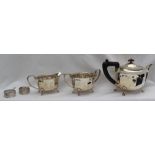 A George VI silver three piece tea set, of oval form with a panelled body on four spreading feet,
