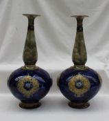 A pair of Royal Doulton stoneware vases, with a tapering neck, bulbous body and spreading foot,