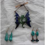 Two pairs of enamel decorated earrings and an enamel decorated brooch in the form of a dragon