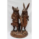 A 19th century Black Forest carved treen figure group in the form of a standing fox with knife and