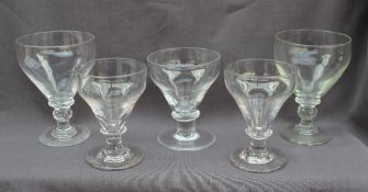 Five assorted 19th century glass rummers of various sizes on ring turned and knopped columns and