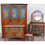 A mahogany chinoserie decorated four piece bedroom suite comprising a triple wardrobe,