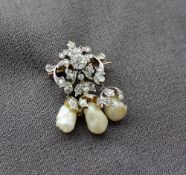 A Victorian diamond and natural shaped pearl set brooch, the central round old cut diamond,