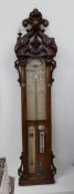 An oak framed "Admiral Fitzroy's barometer", with a leaf carved cresting,