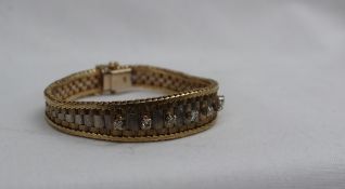 A two tone 9ct yellow and white gold and diamond bracelet,