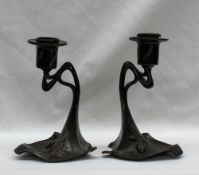 A pair of WMF desk candlesticks, decorated with a pine cone and leaves, marked WMF EP OX, 329, 13.